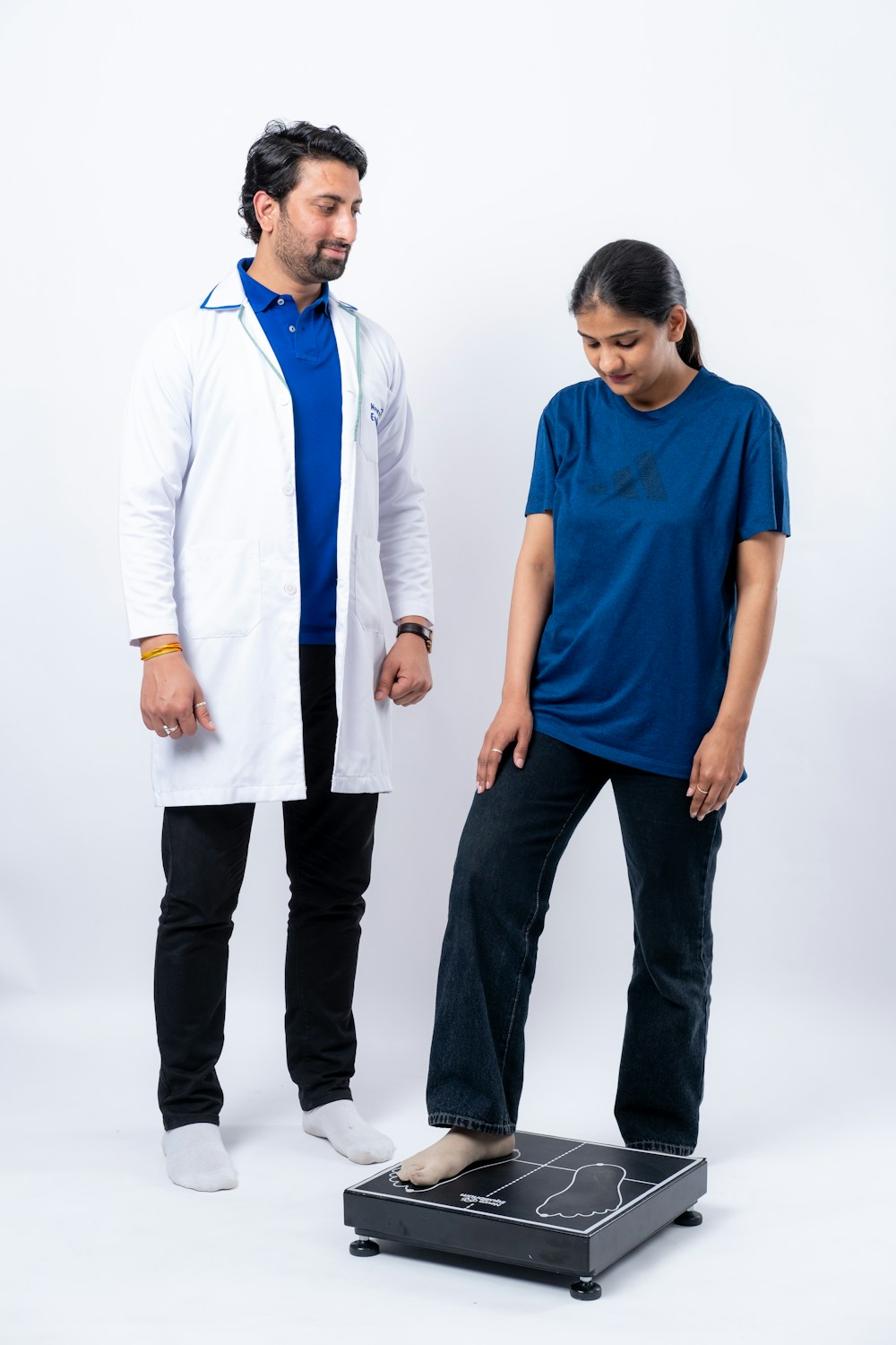 Doctor supervising a body composition scale reading